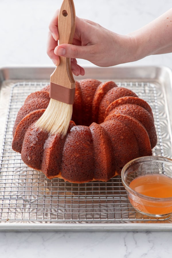 Brushing the warm cake with grapefruit cordial.