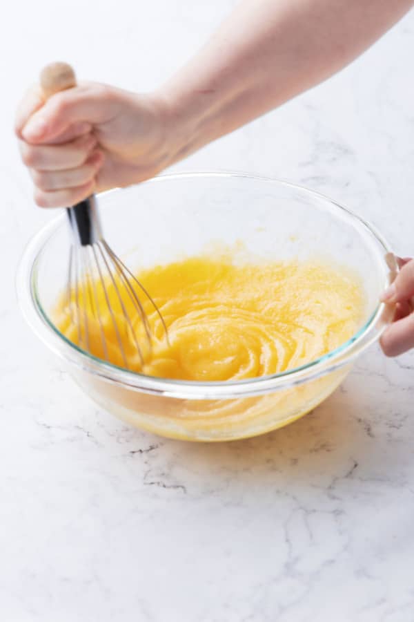 After whisking the eggs into the sugar the mixture will be smooth and pale yellow.