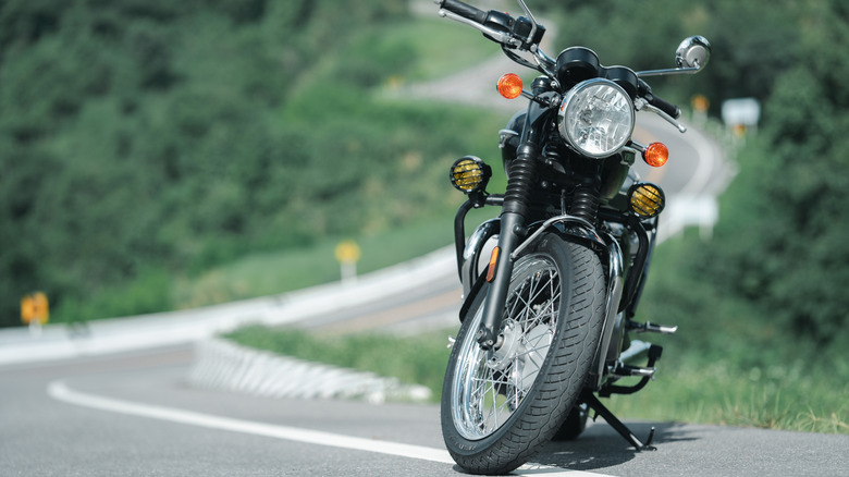 Lone motorcycle on side of the road.