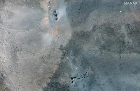 Maxar Technologies/Handout via Reuters Satellite image shows holes and craters on a ridge at the Fordo nuclear facility in Iran on 22 June.