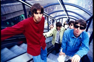 British rock band Oasis (Noel Gallagher, Liam Gallagher, Paul McGuigan, Paul Arthurs, Tony McCarroll) on Market St, Manchester, 2 August 1994
