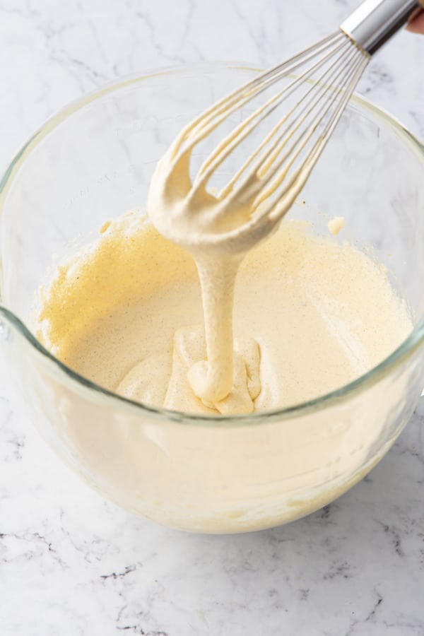 After whisking, the egg yolk mixture will be lightened in color and fall off the whisk in continuous ribbons.