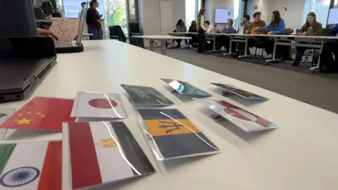 Badges with flags of the world, used by students at the "Mock COP" conference