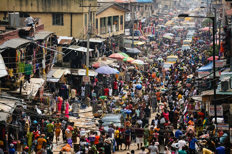 Crowds of people and market stalls in Lagos, Nigeria.